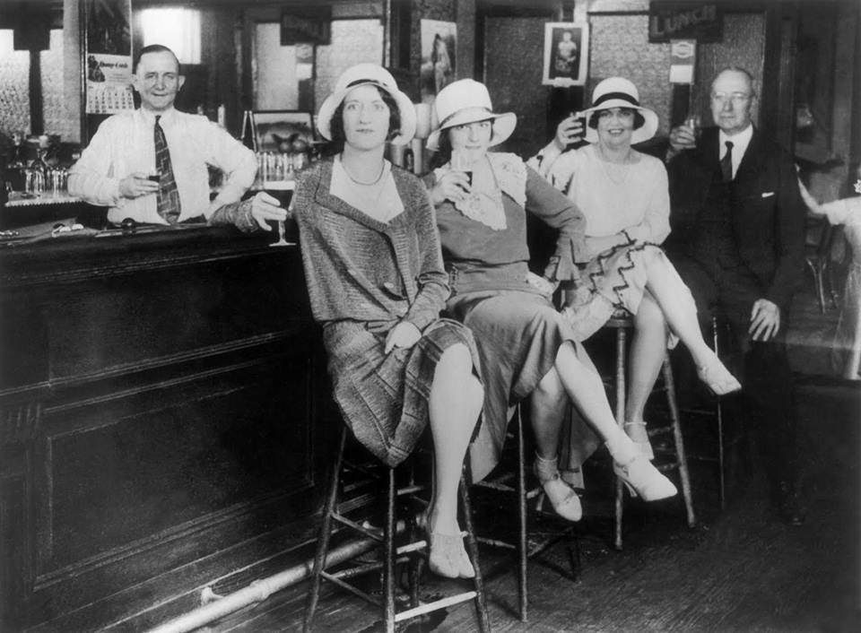 Ladies having a drink at a speakeasy bar during Prohibition, 1920s.png