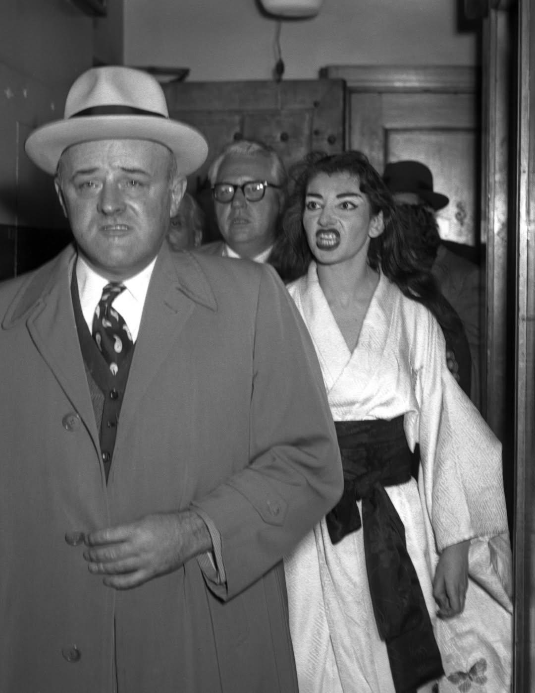 Opera diva Maria Callas snarls at Federal Marshal Stanley Pringle after he served her with a summons for breach of contract, 1955.jpeg