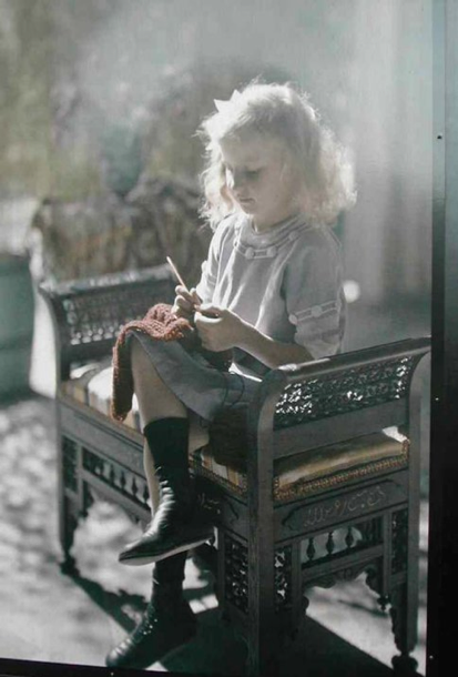 Little girl in a backless chair doing some needle work, circa 1910s. Autochrome lumiere.png