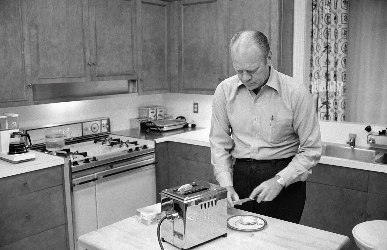 President Gerald Ford prepares English muffins, which he toasted in the kitchen of the family quarters at the White House - Sept 5, 1974.jpeg