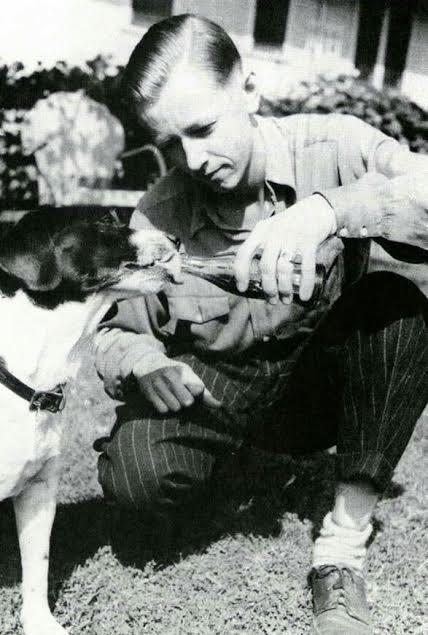 Charles Schulz (c. 1940) sharing a pop with his beloved childhood dog Spike. Spike would later become the inspiration for some of Snoopy's behavior, perhaps even his love of root beer.jpeg