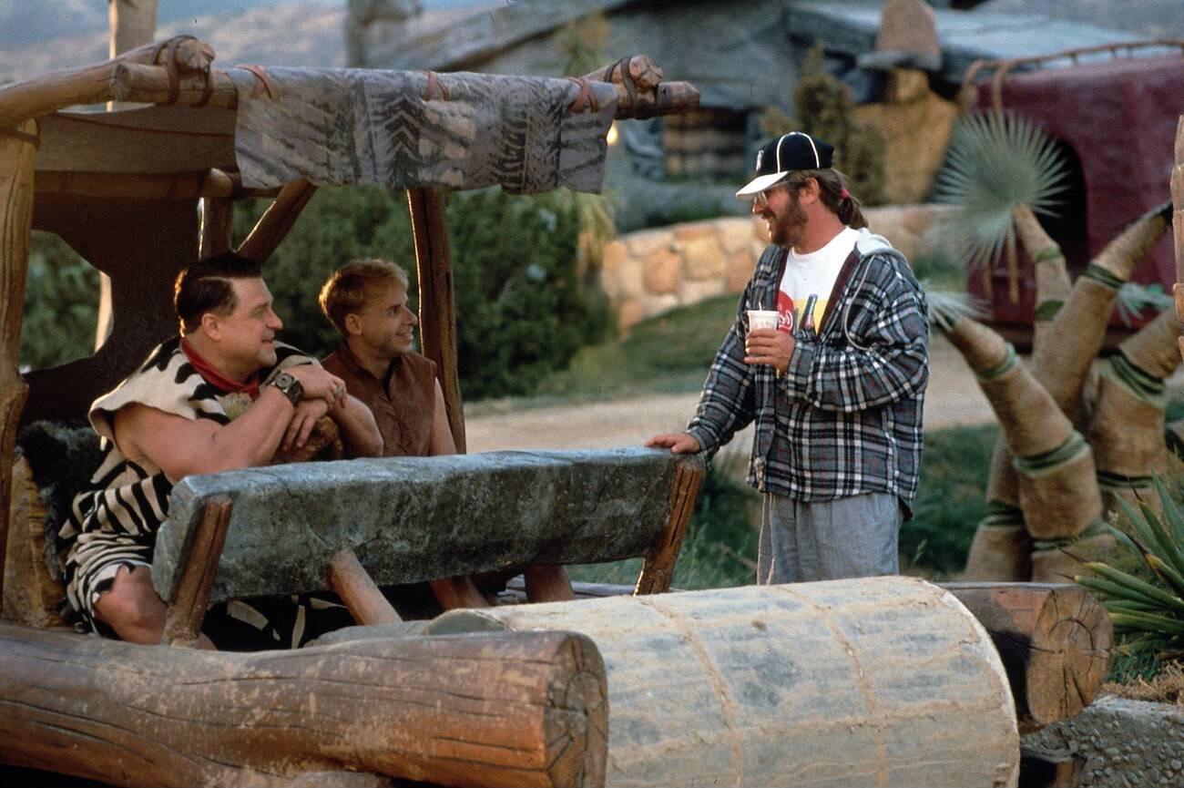 John Goodman, Rick Moranis and director Brian Levant on the set of 'The Flintstones' in 1994.jpeg