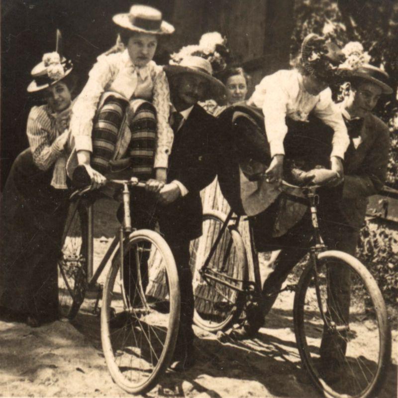 Some ladies getting ready to try a bike tric, with some help. Honestly i have seen my dad do this so I know is possible to do. Circa early 1900s.jpeg