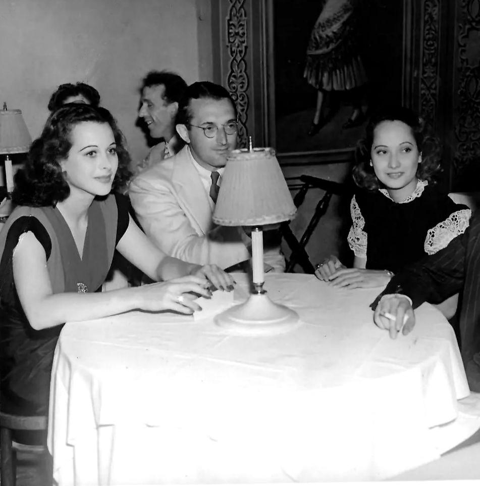 Hedy Lamarr, Tommy Dorsey and Merle Oberon at a nightclub (c.1939).jpeg