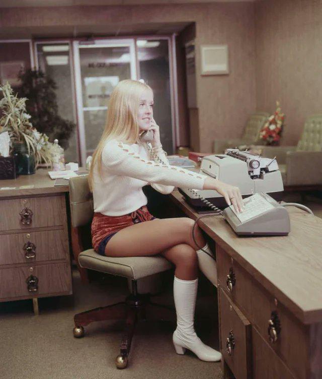 A young secretary showing off the latest fashion and demonstrating the cutting-edge office tech of the time, 1971.jpeg