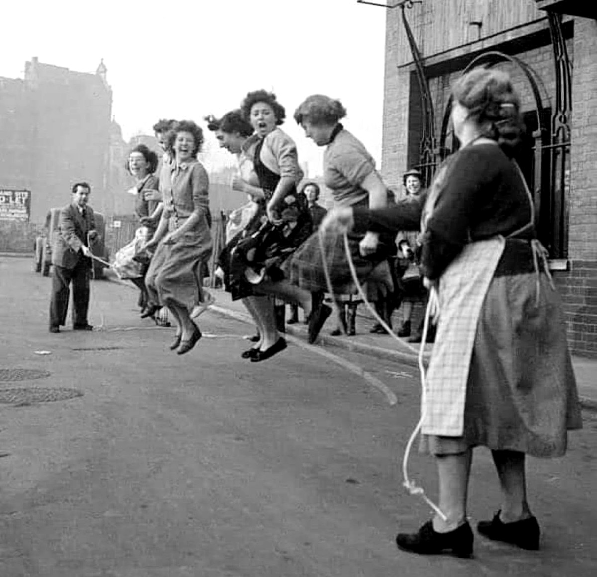 Working women on a lunch break skipping in the street of London, 1953.jpg