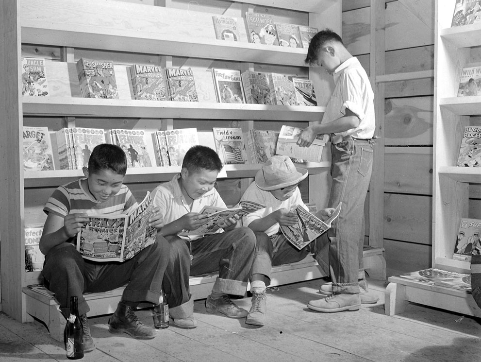 evacuees from Sacramento at the newsstand in Newell, California 1942. NARA.jpg